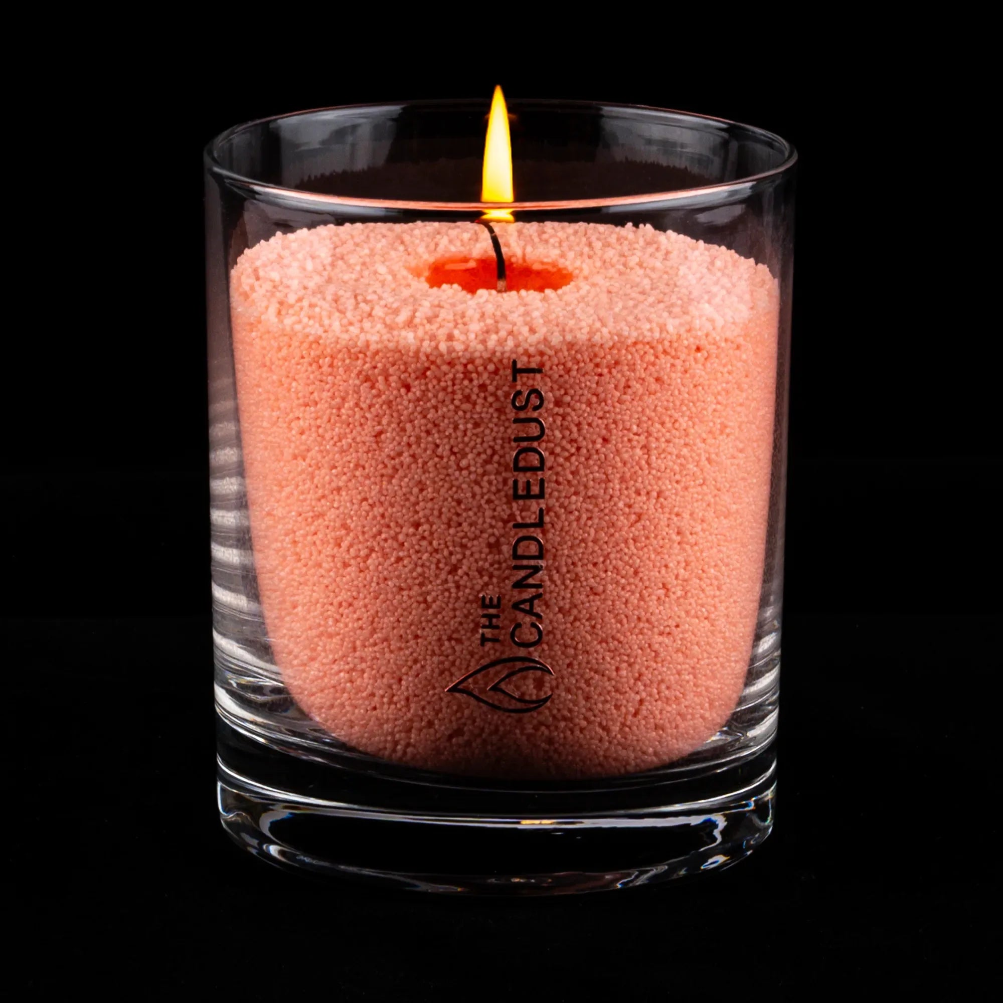 Bougie de rituel parfumé en sable rose dans un verre transparent, allumée et présentée sur fond sombre, idée cadeau élégante pour créer une ambiance douce à la maison – KoolKado