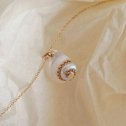 Idées cadeaux pour femme – collier coquillage beige en ambiance douce, bijou naturel et poétique