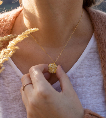 Pendentif céleste doré présenté dans un écrin blanc prêt à offrir. Idée cadeau femme.