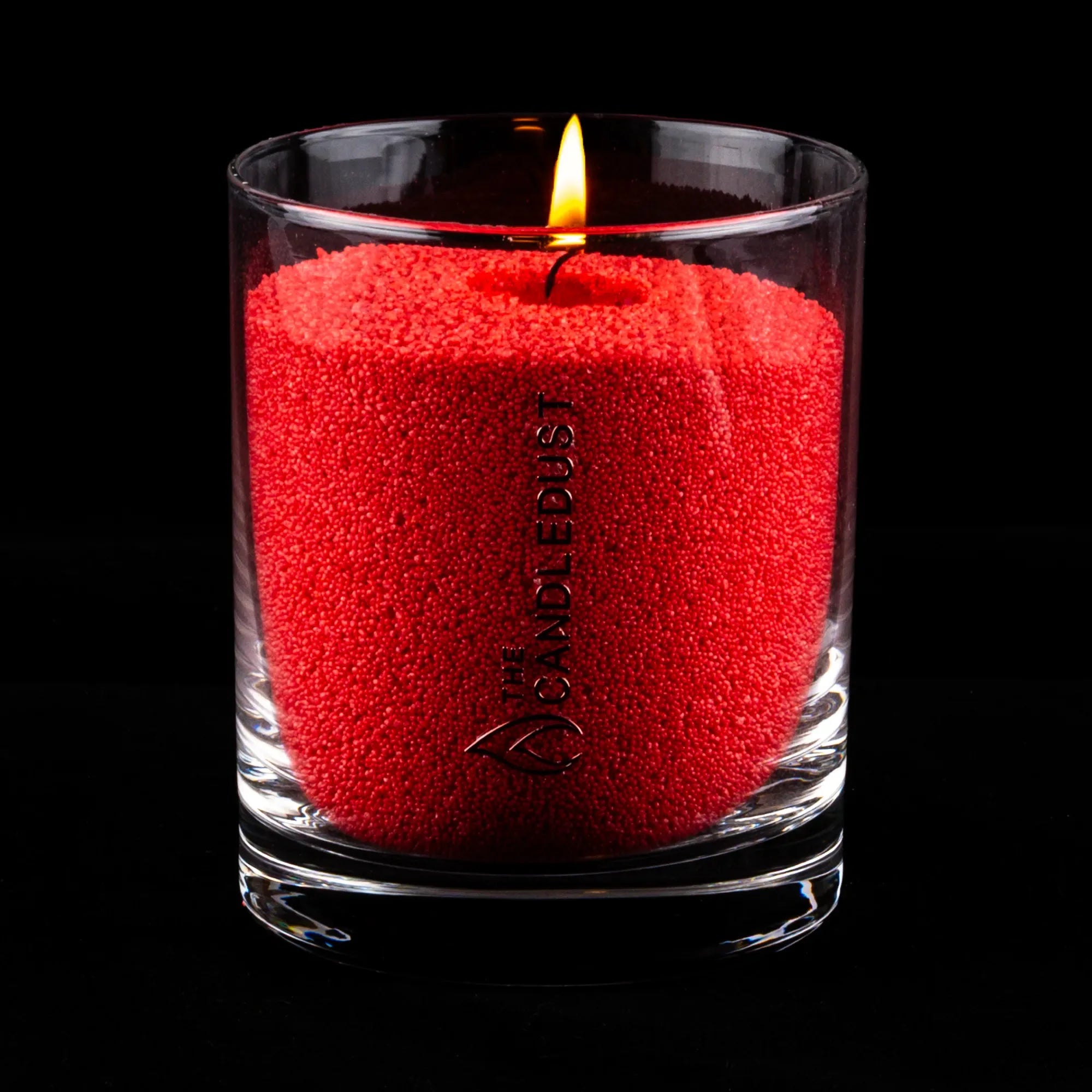 Idées cadeaux bougie décorative Candledust allumée, couleur sable rouge, parfaite pour créer une ambiance conviviale et raffinée à la maison.